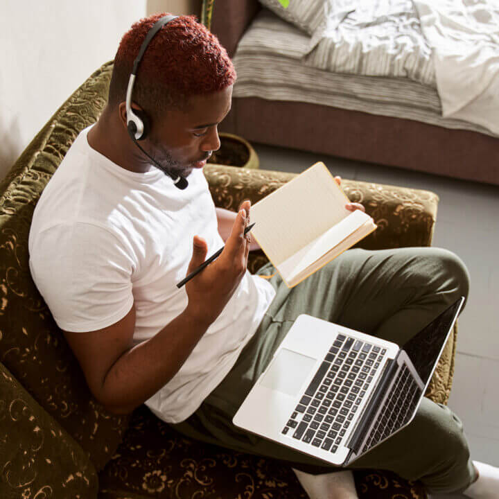 Person attending webinar on their laptop in their home.