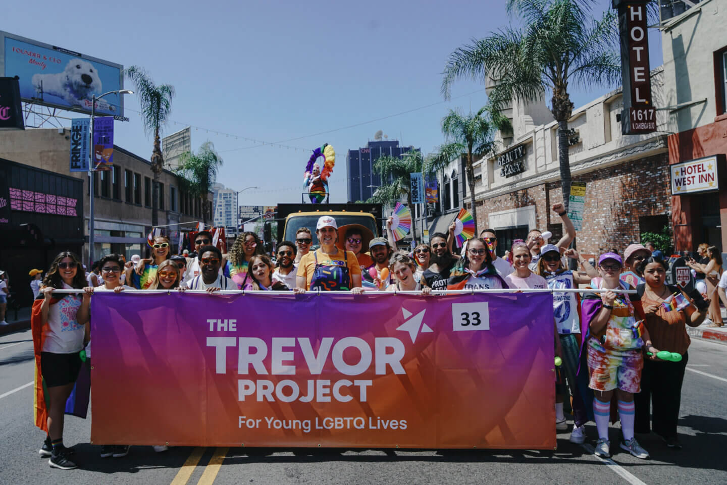 Parade photo of people with a banner that reads "The trevor Project for Young LGBTQ Lives"